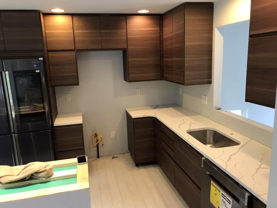 A kitchen with wooden cabinets and a stainless steel sink