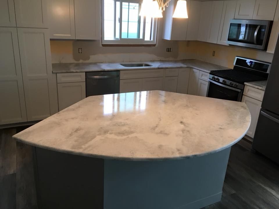 A kitchen with a large island in the middle of it