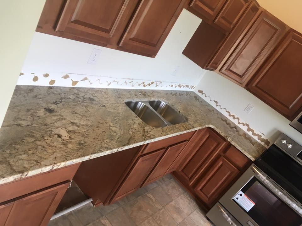 A kitchen with stainless steel appliances and granite counter tops