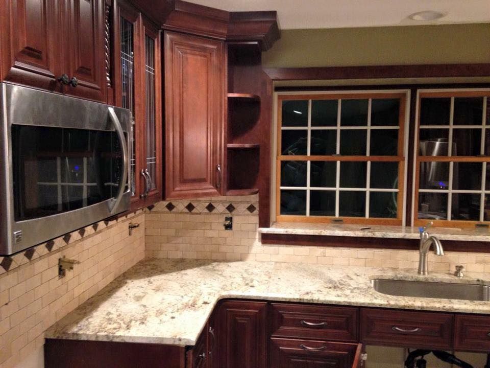 A kitchen with stainless steel appliances and wooden cabinets