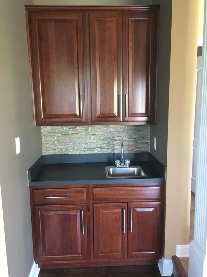A small kitchen with wooden cabinets and a sink.
