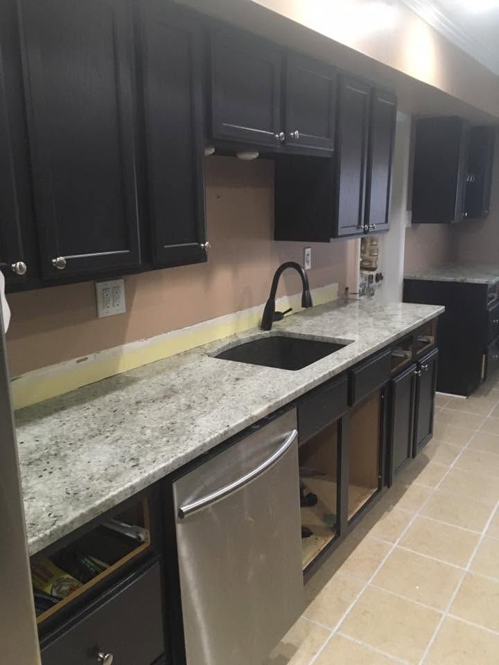 A kitchen with stainless steel appliances and granite counter tops