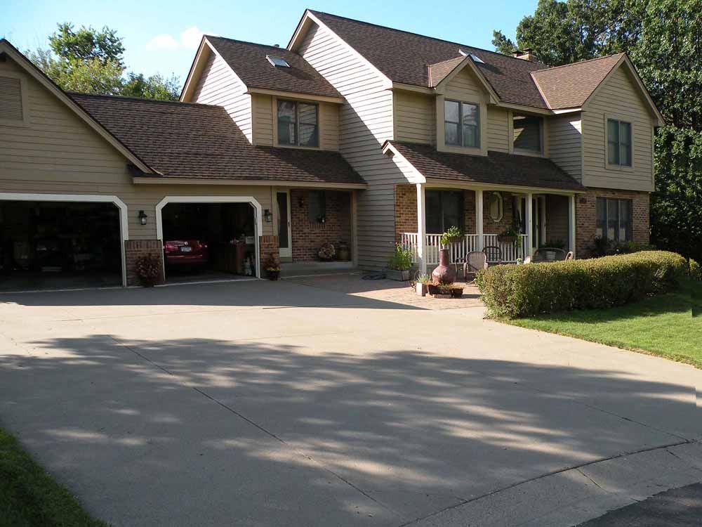 a large house with a car parked in the garage