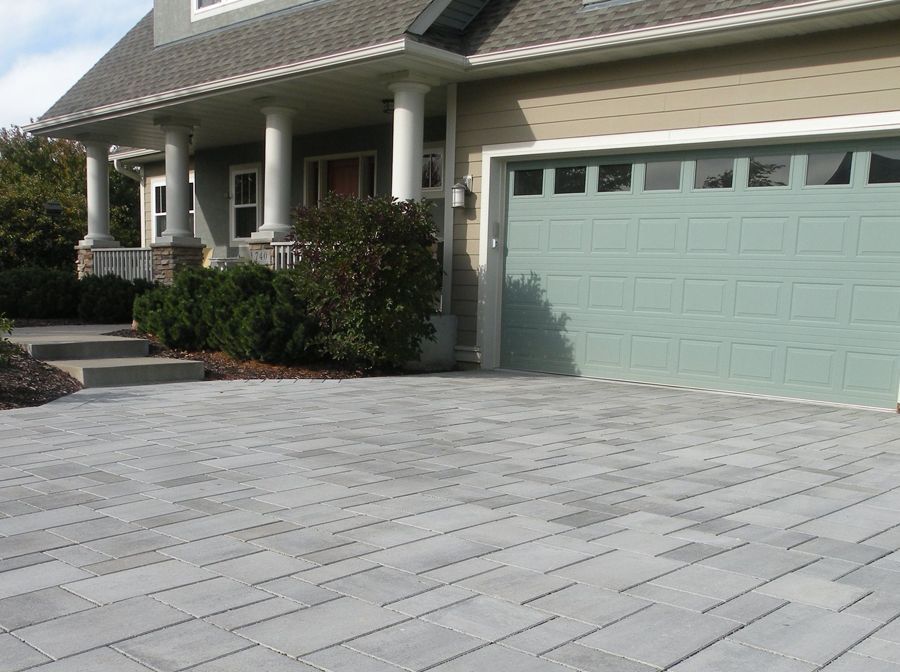 A house with a blue garage door and a driveway