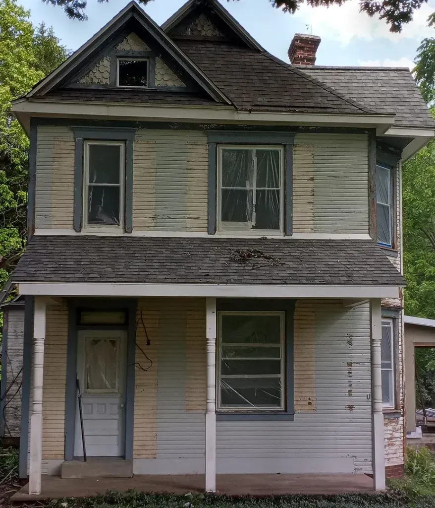 A house with a roof that has a chimney on it.