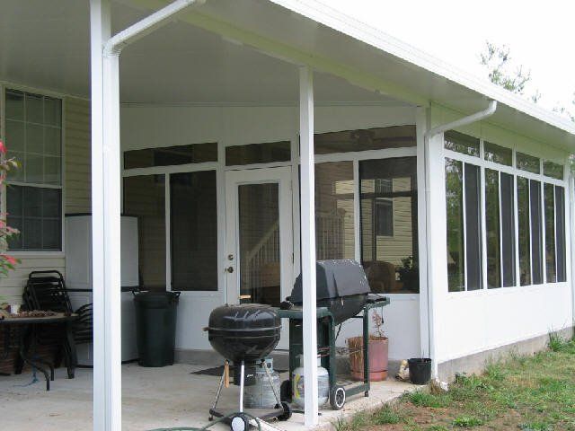 There is a grill on the porch of a house.