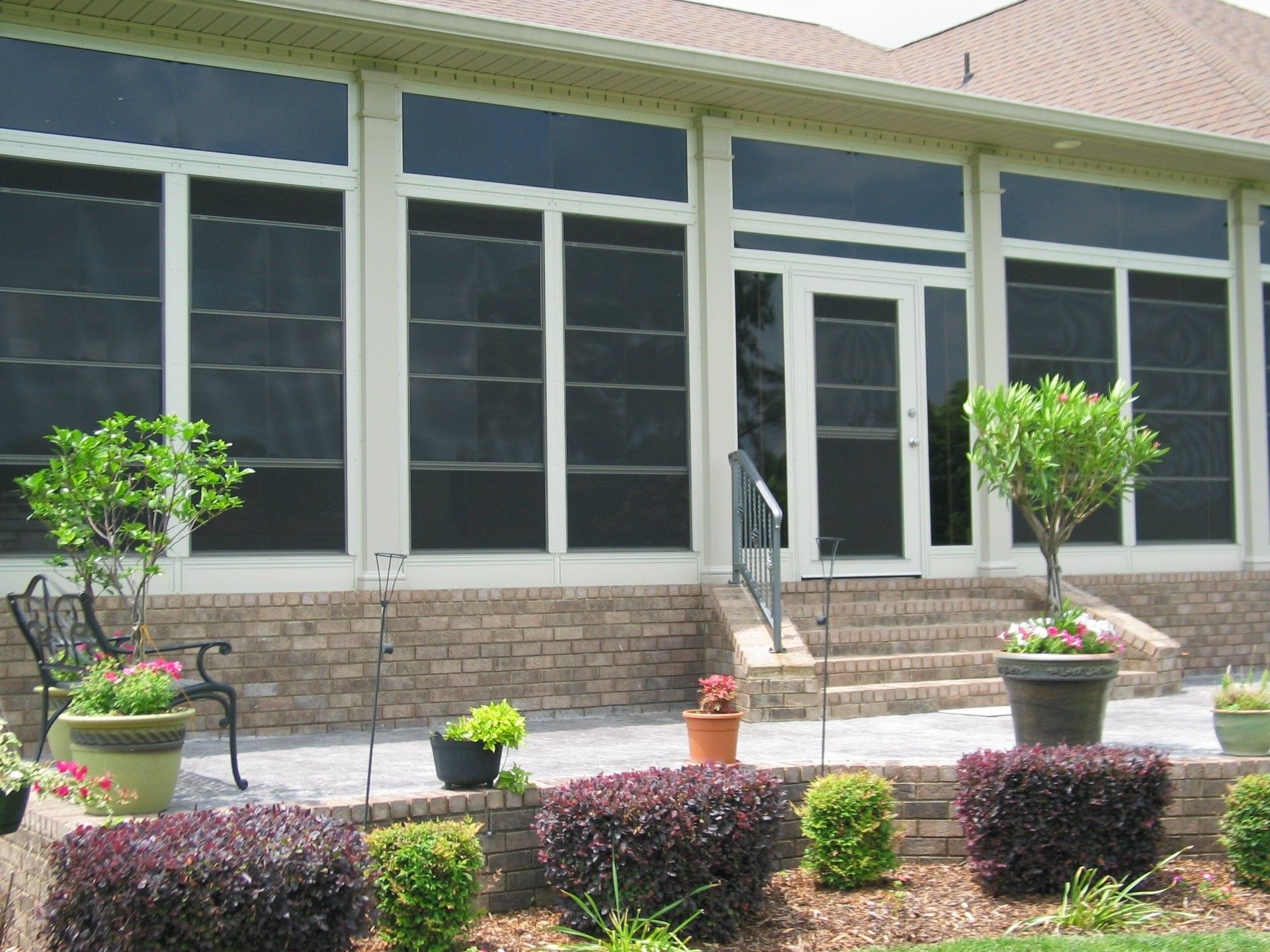 A house with a screened in porch and stairs