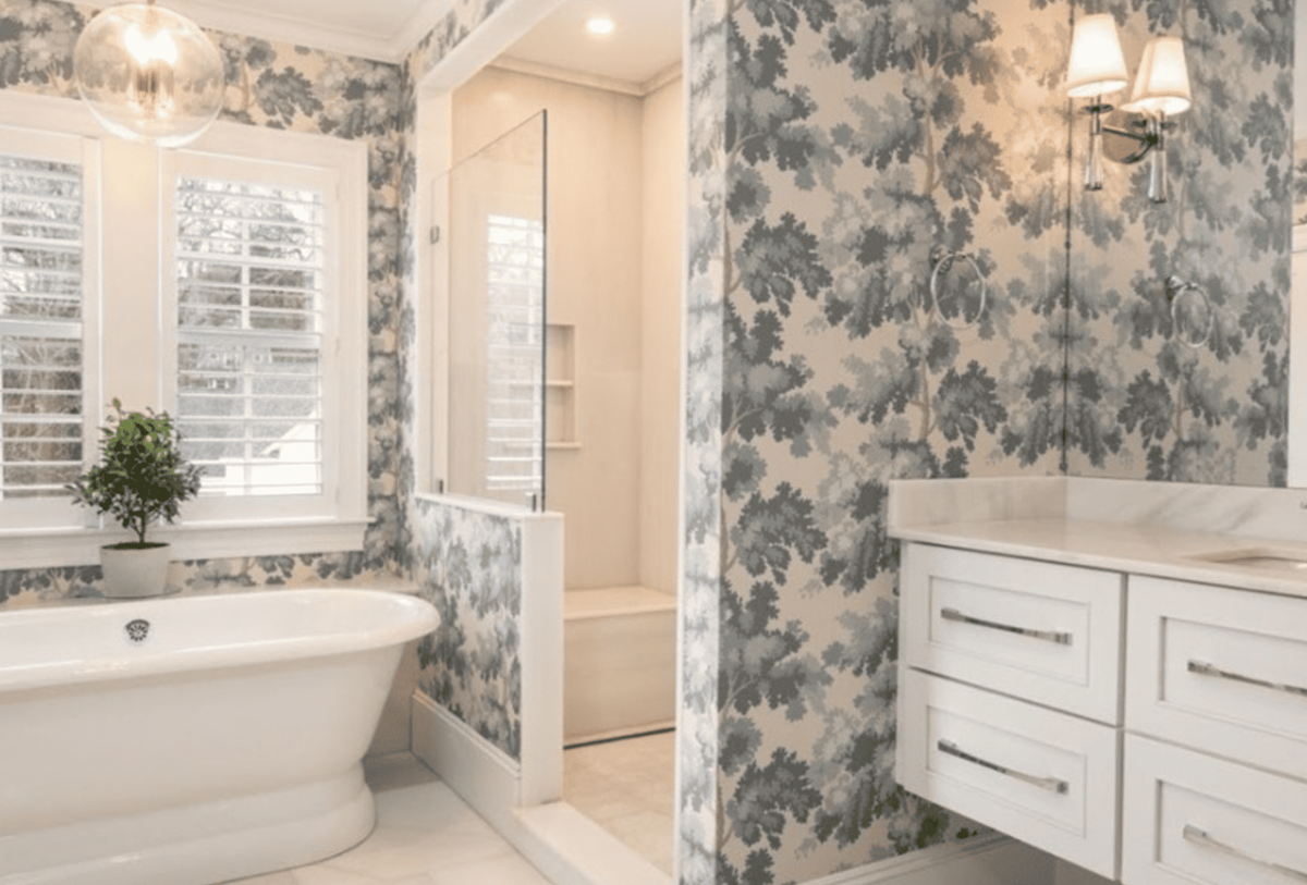 A bathroom with a bathtub , sink , and shower.