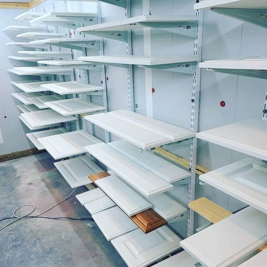 A room filled with lots of white shelves