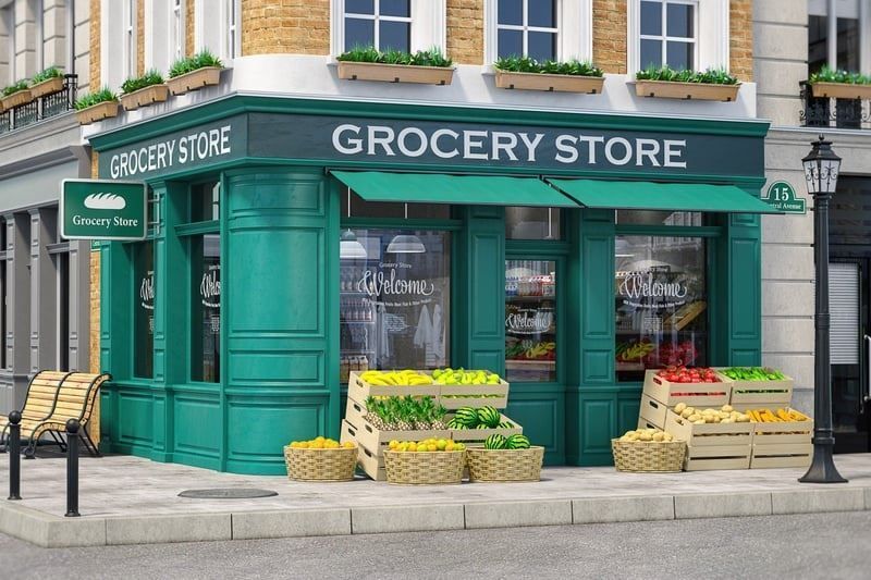 A grocery store with baskets of fruit and vegetables in front of it.
