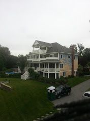 A large house with a car parked in front of it.