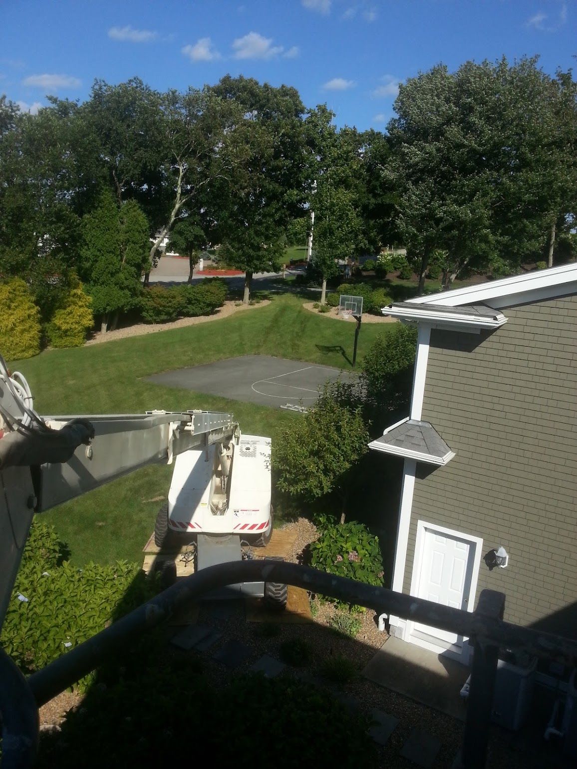 A white truck is parked in front of a house