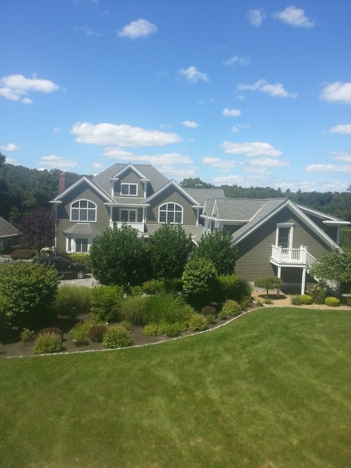 A large house with a lush green lawn in front of it