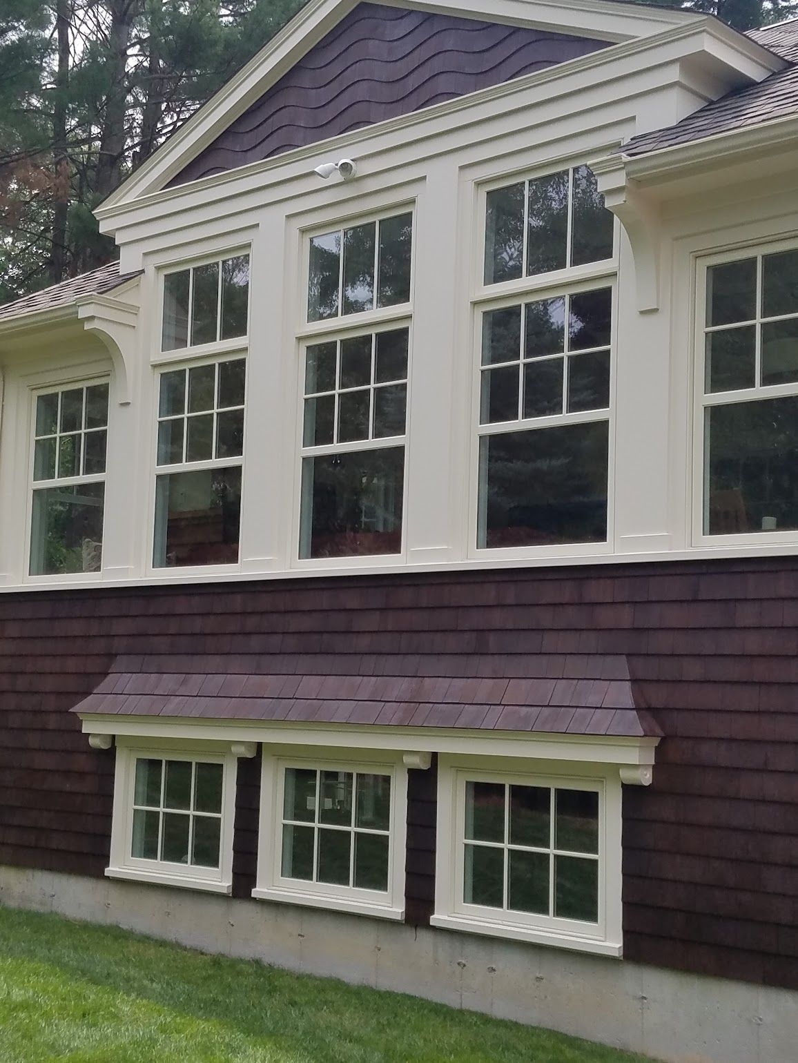 A house with a lot of windows and a purple roof