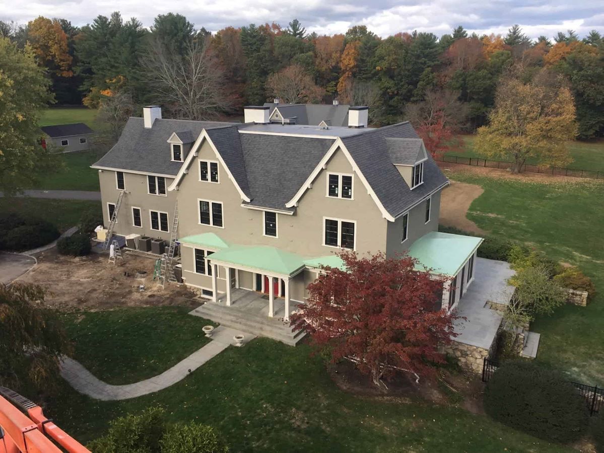 An aerial view of a large house surrounded by trees