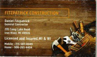 Business card for Fitzpatrick Construction with contact details, tools, and wood background.