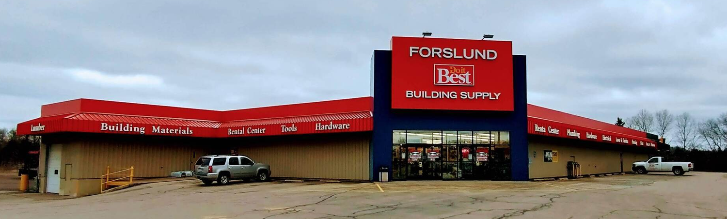Building with red roof and blue signage, “Fortunio B&B” store. Gray vehicle and truck are parked outside.