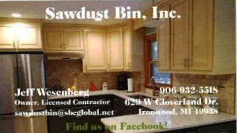 Business card for Sawdust Bin, Inc. with a kitchen photo, contact info: phone, email, Facebook, and Ironwood, MI address.