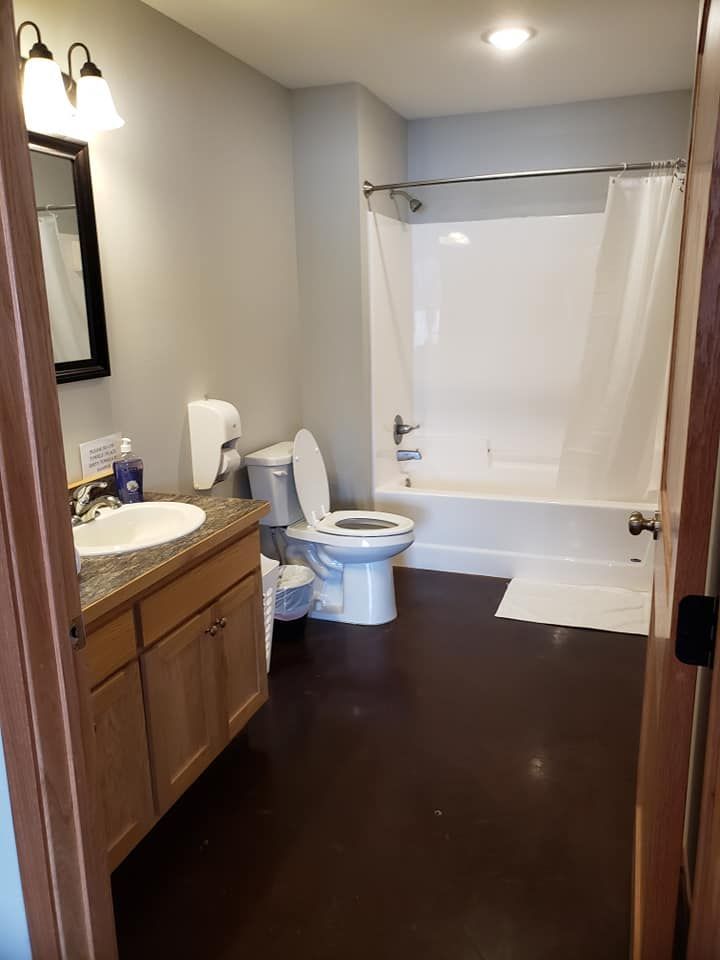 A bathroom with a toilet , sink and bathtub