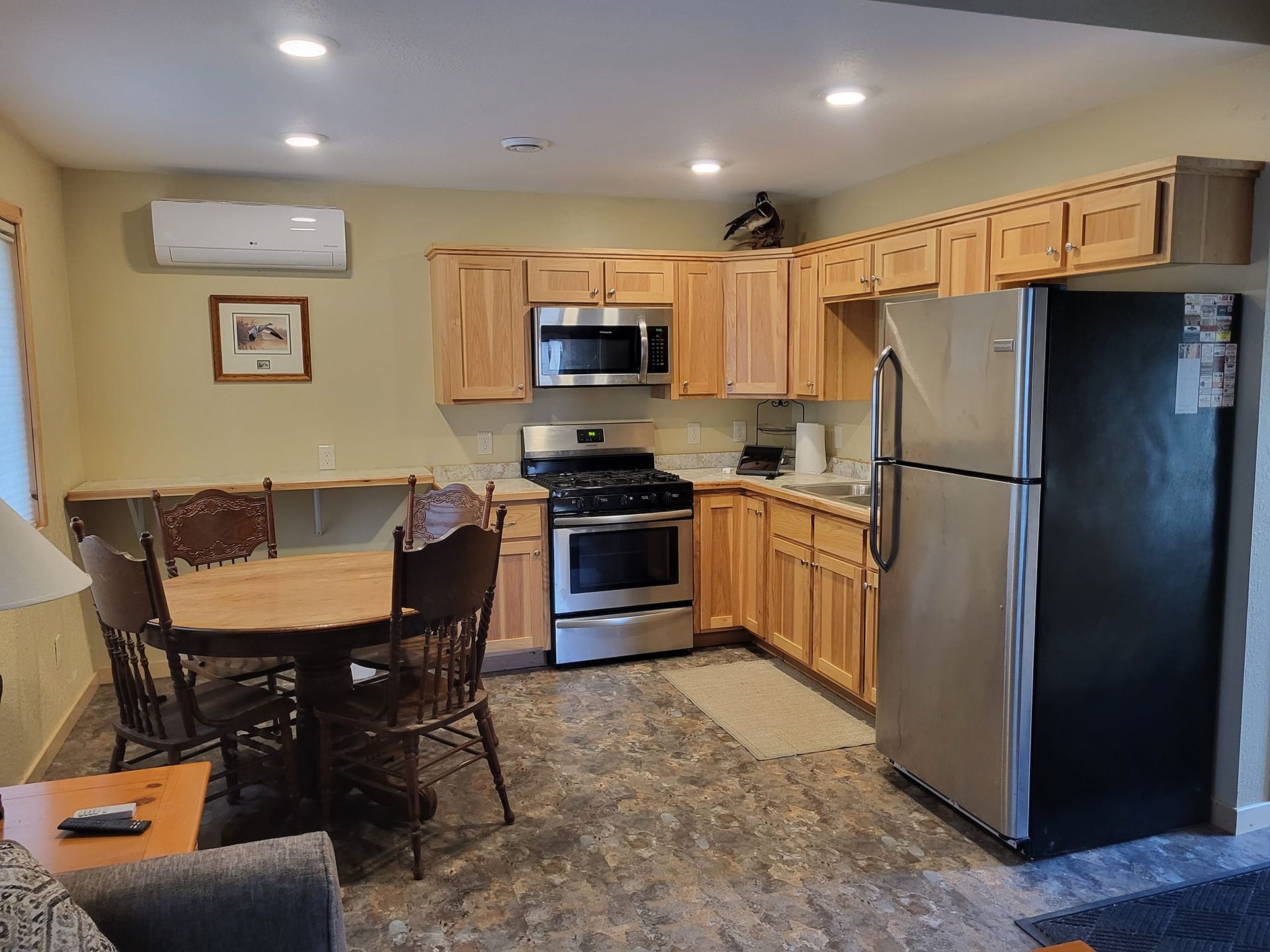 A kitchen with a table and chairs and a refrigerator