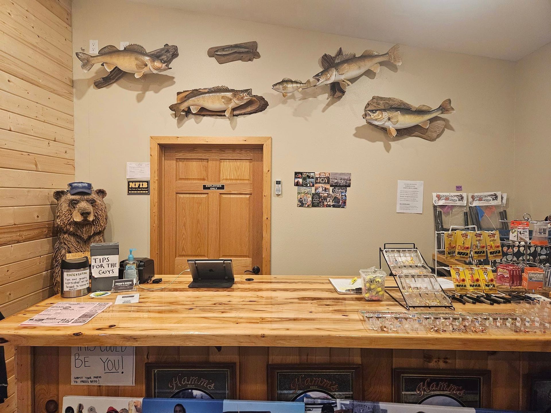 A wooden counter in a room with fish on the wall.