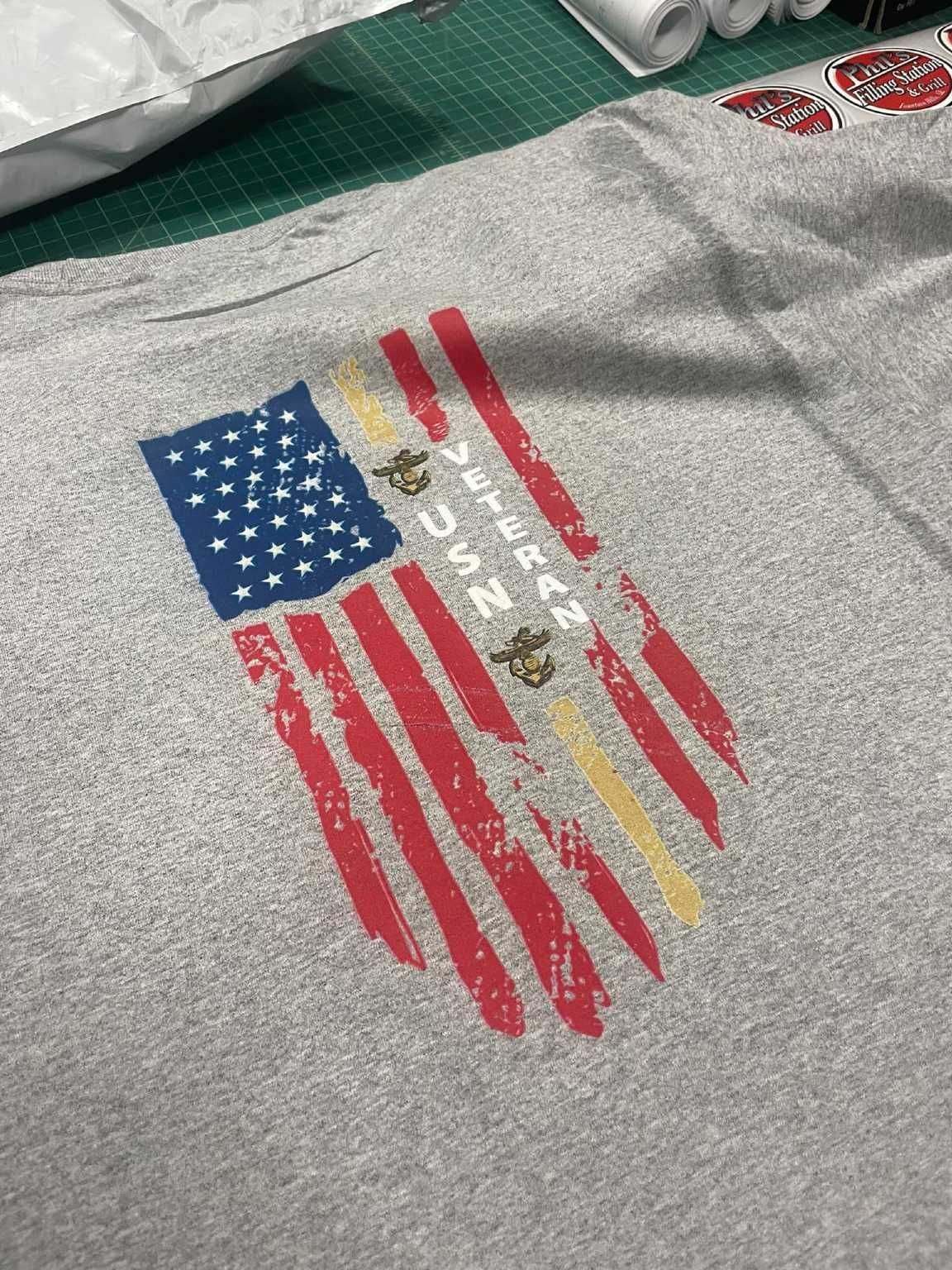 A close up of a t-shirt with an american flag on it.