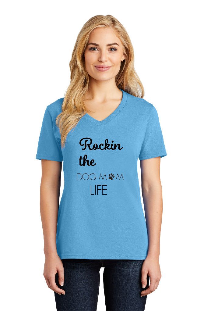 A woman is wearing a blue t-shirt that says rockin the dog way life