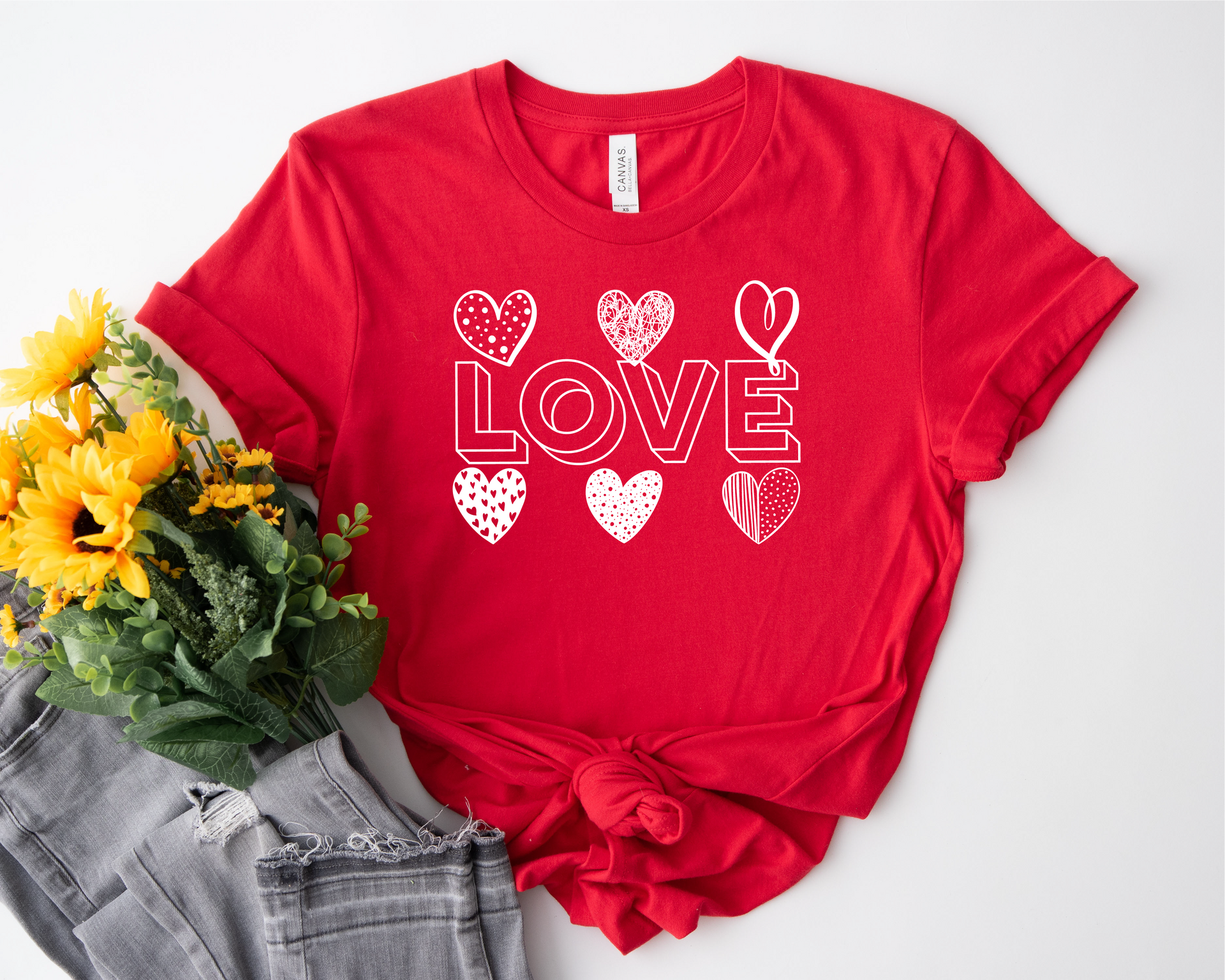 A red t-shirt with the word love and hearts on it.