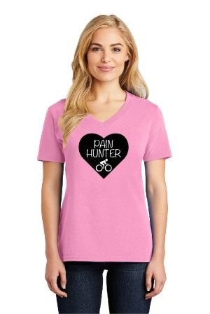 A woman is wearing a pink t-shirt with a heart on it that says pain hunter.