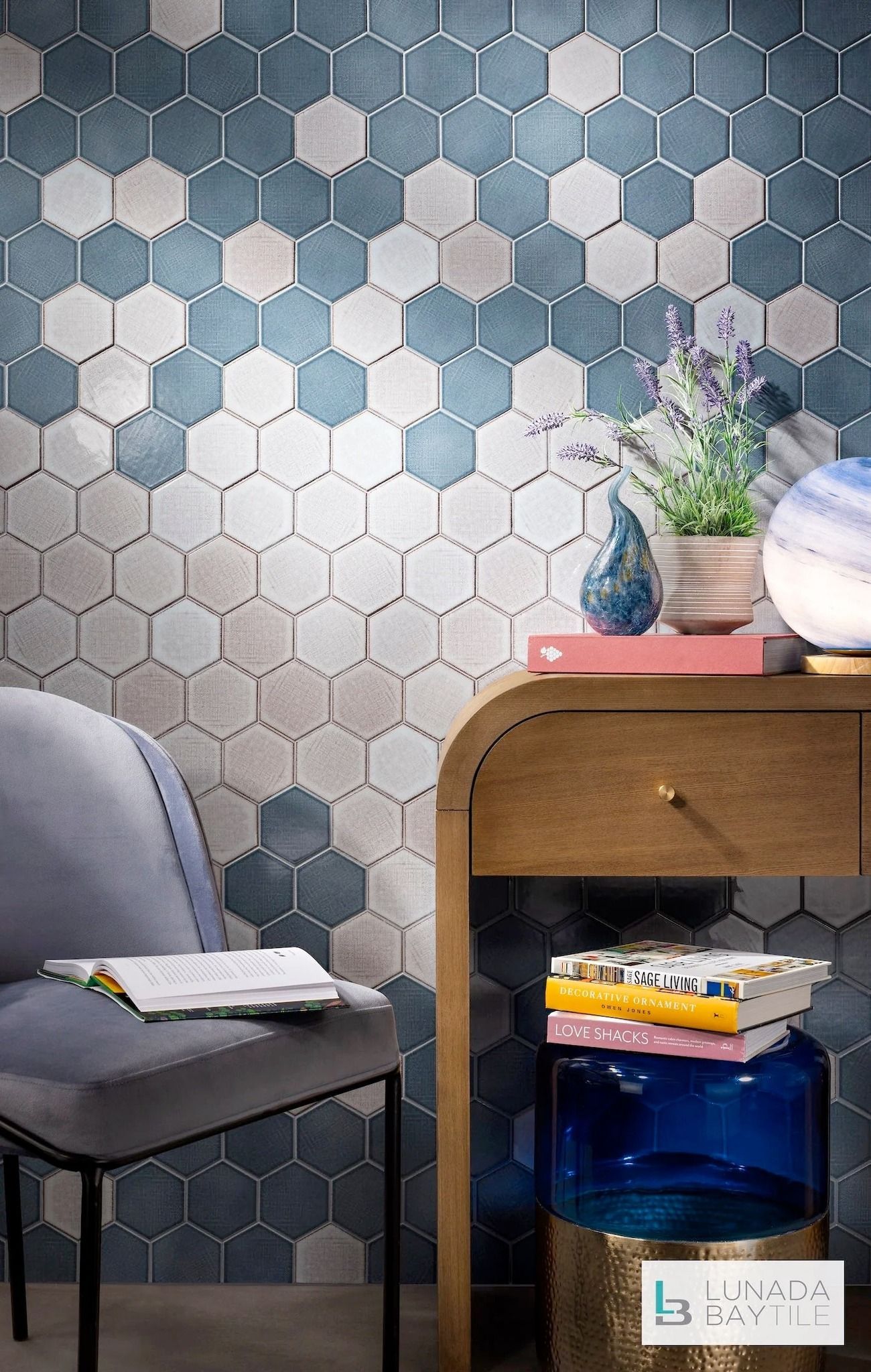 Hexagon tile wall with chair, desk, and decor in blue and neutral tones.