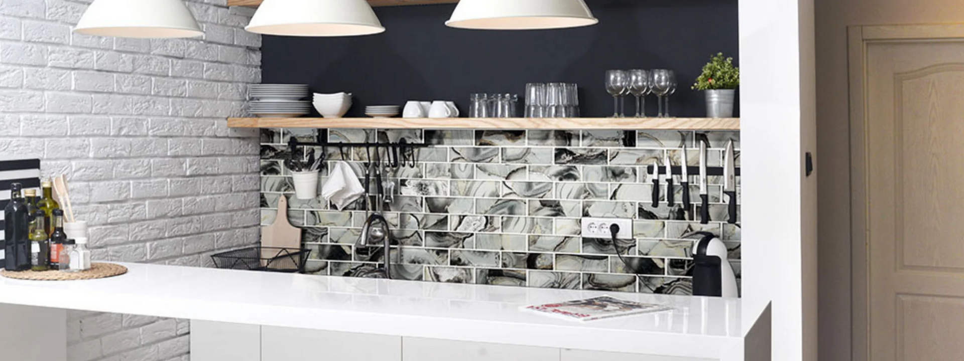 A kitchen with a brick wall and a white counter top.