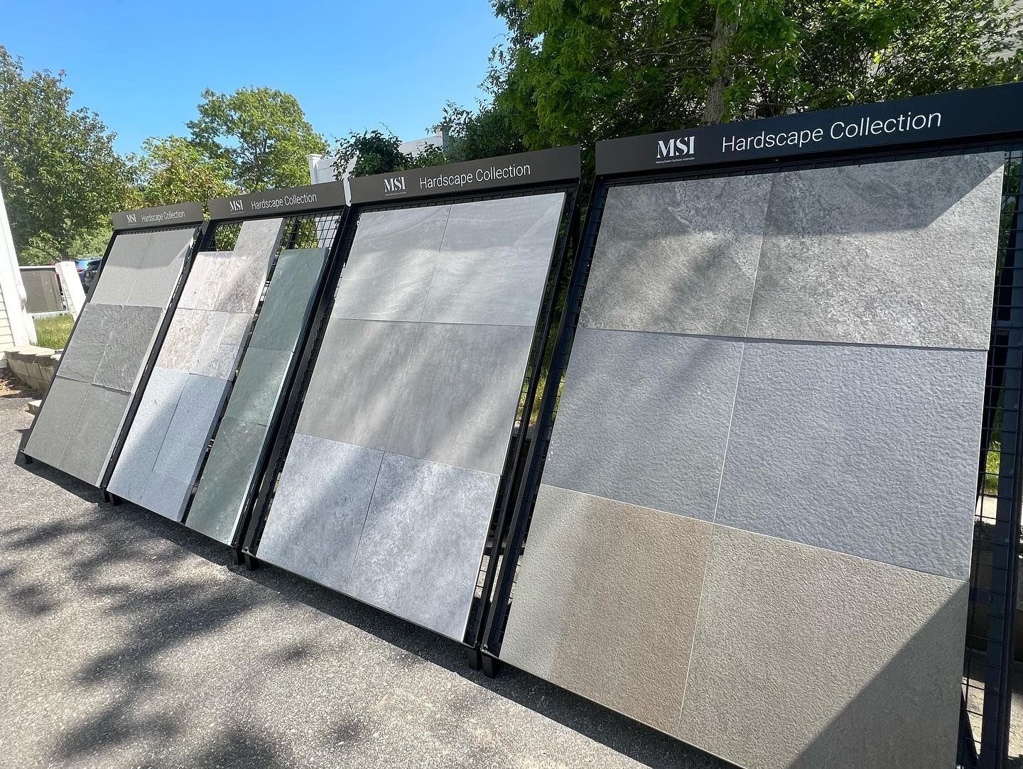 A row of tiles are displayed on a rack in a store.