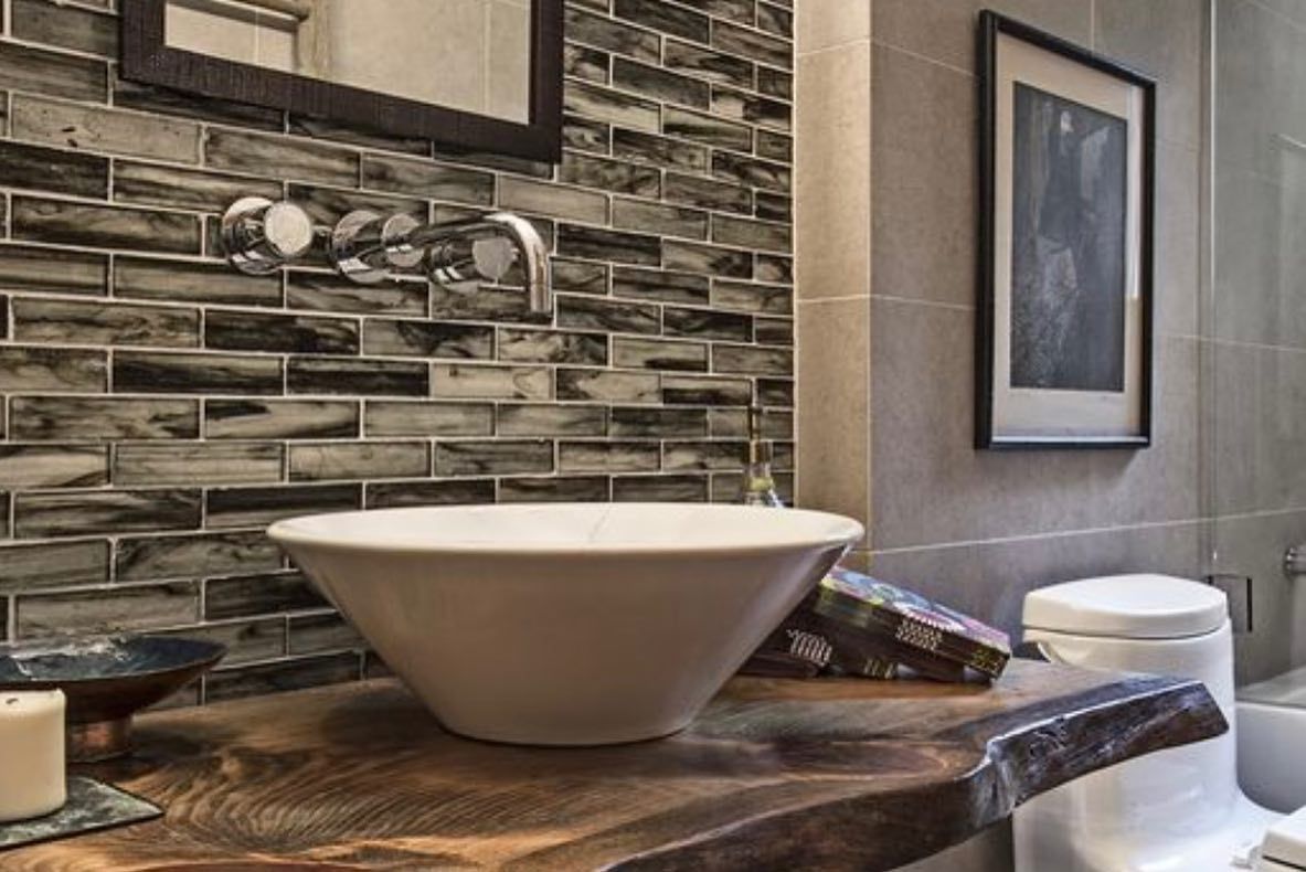 A bathroom with a sink , toilet and mirror.