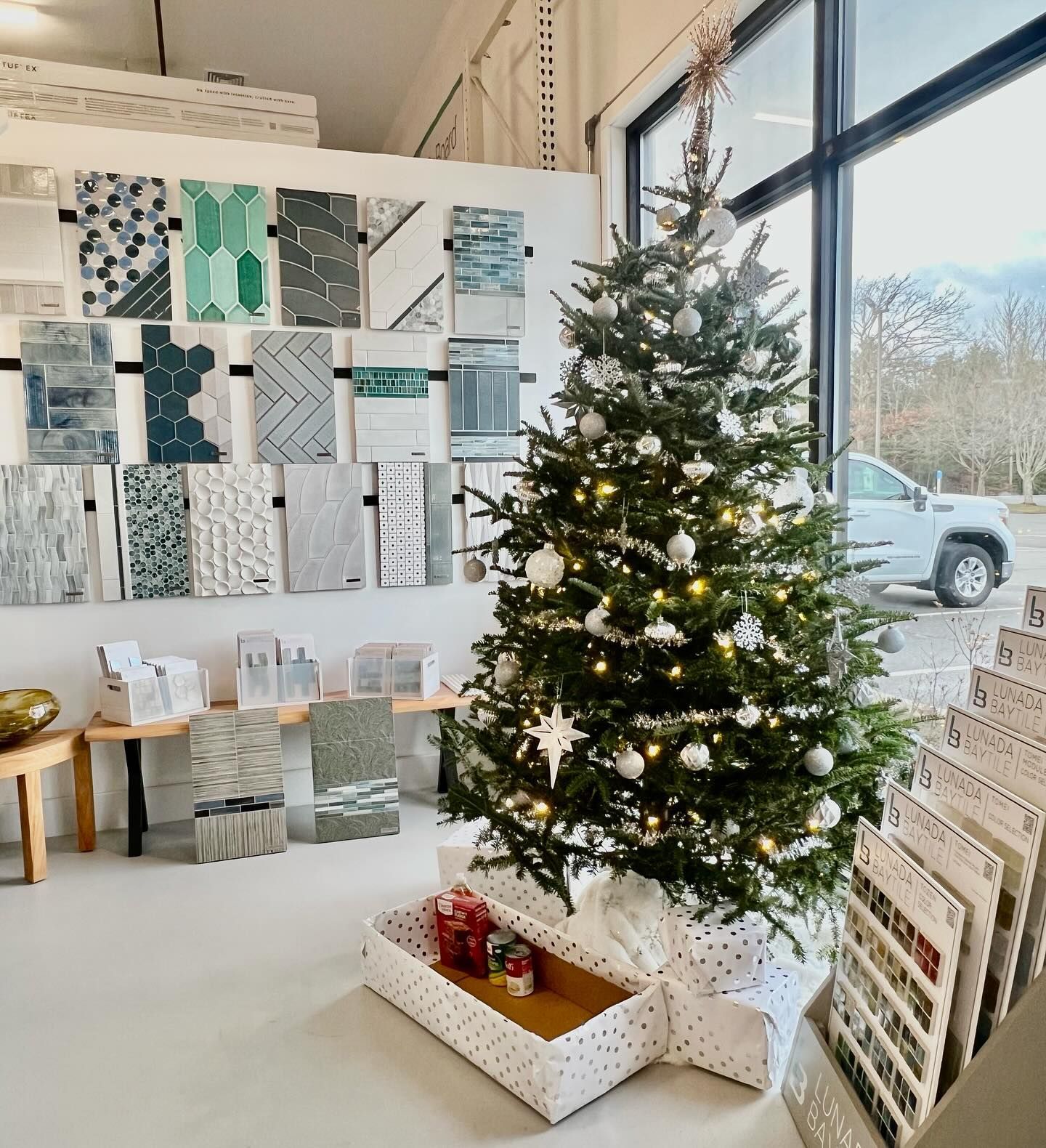 A christmas tree is sitting in a room next to a window.