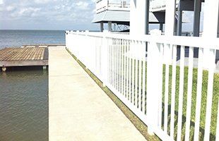 Fence between water and house