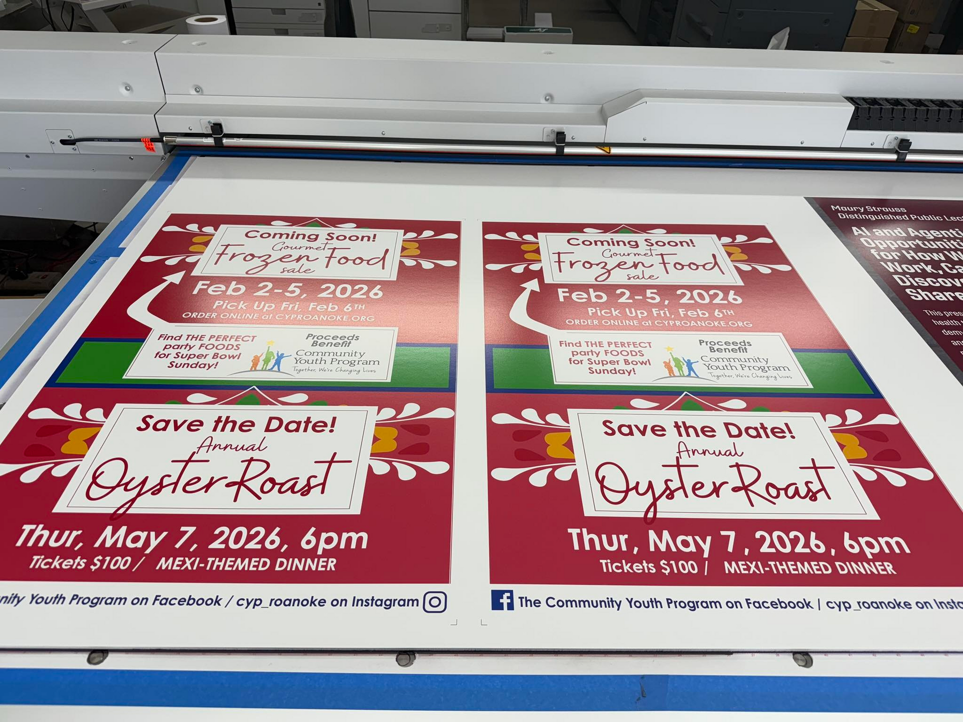 Two identical posters on a printer bed advertising a 
