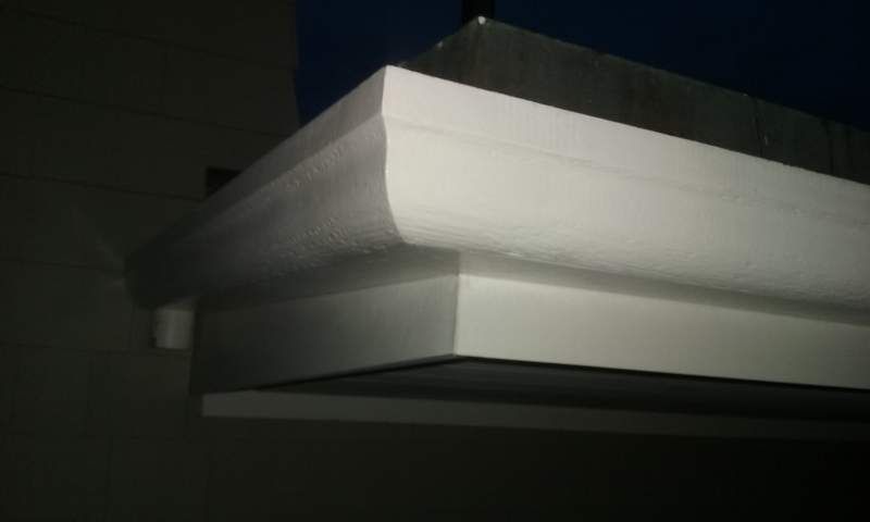 White molding detail with curved top edge, installed on a wall.