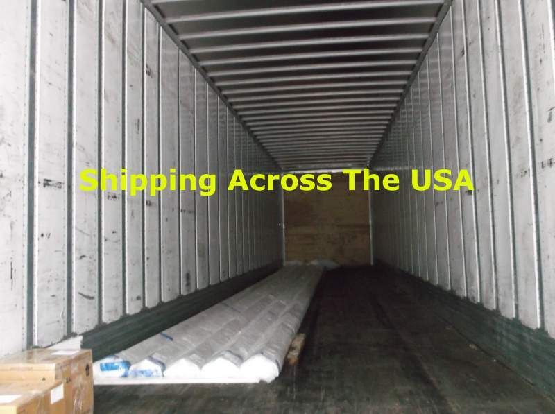 Inside a shipping container, containing a rolled item and a box, ready for transport across the USA.