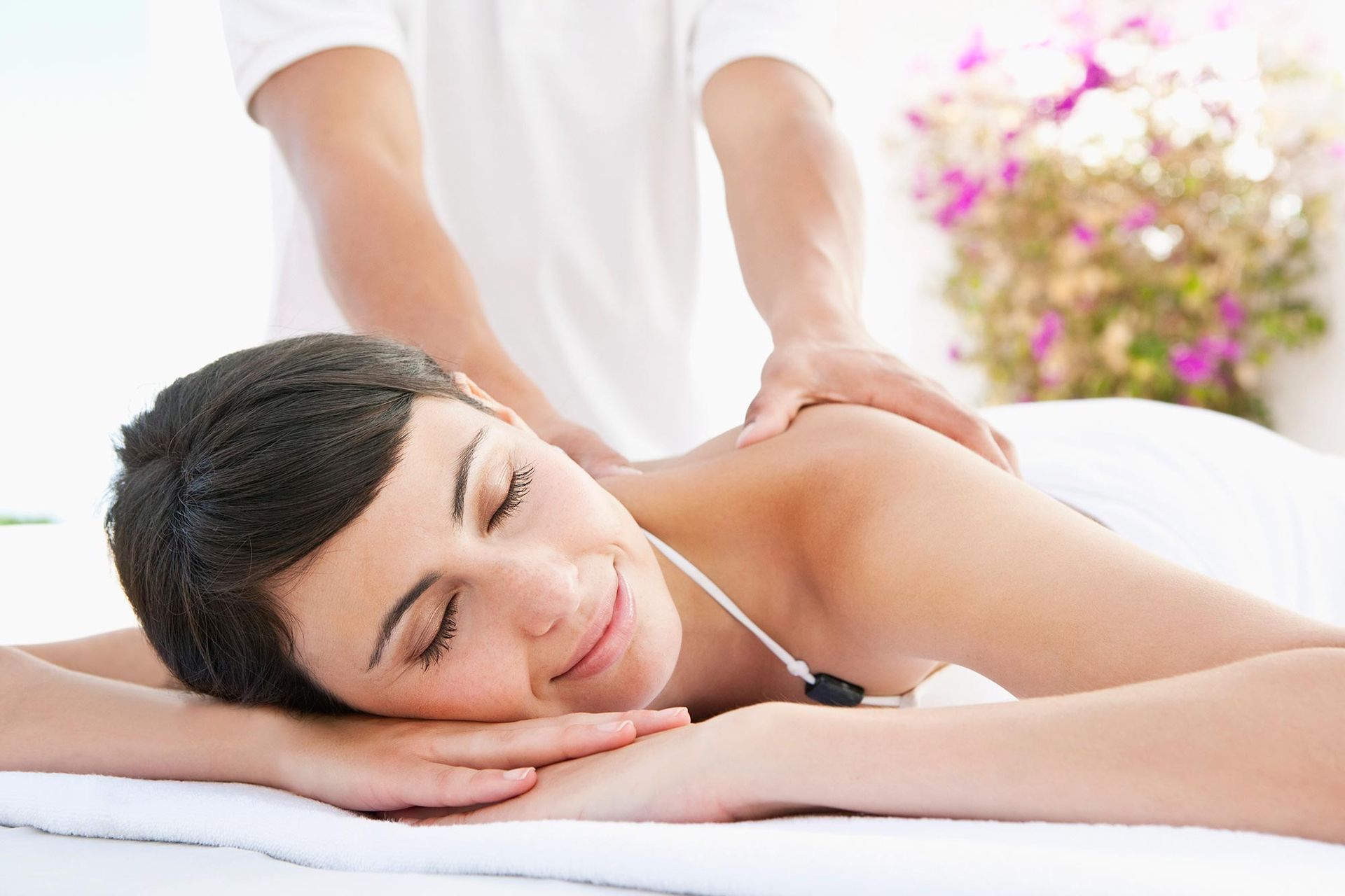 A woman is laying on a massage table getting a massage.