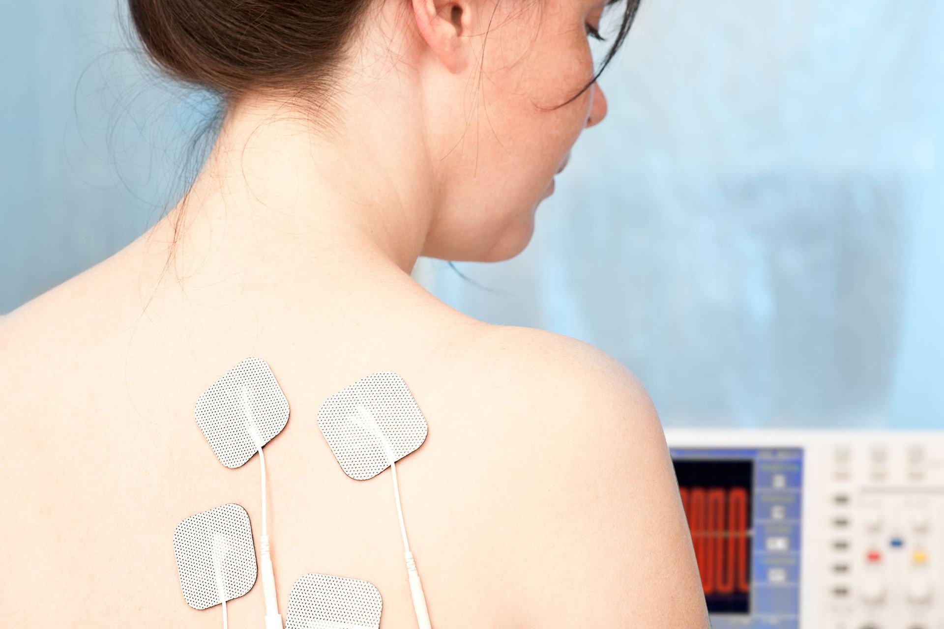 A woman is getting a microcurrent therapy