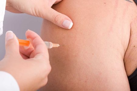 a therapist administering an injection to a patient