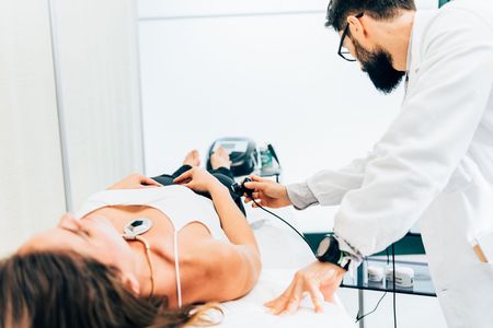 a woman is having an ultrasound therapy