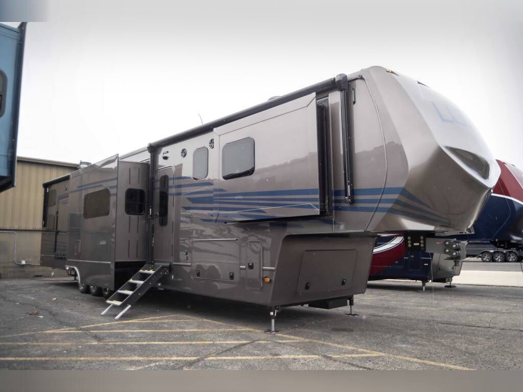 A large rv is parked in a parking lot.
