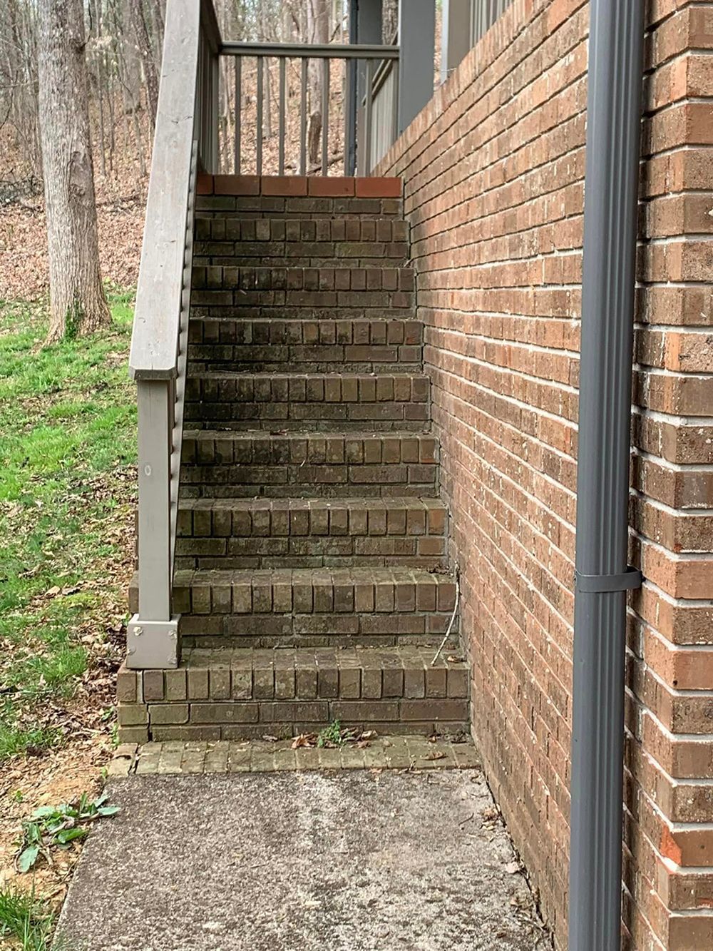 A set of stairs leading up to a brick wall