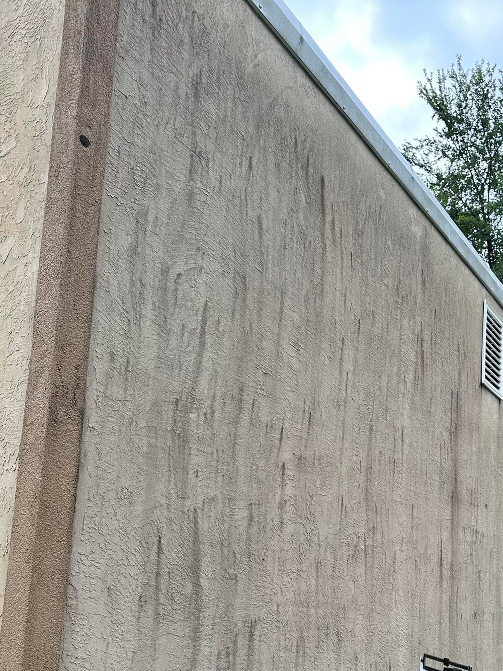 A close up of a dirty wall of a building
