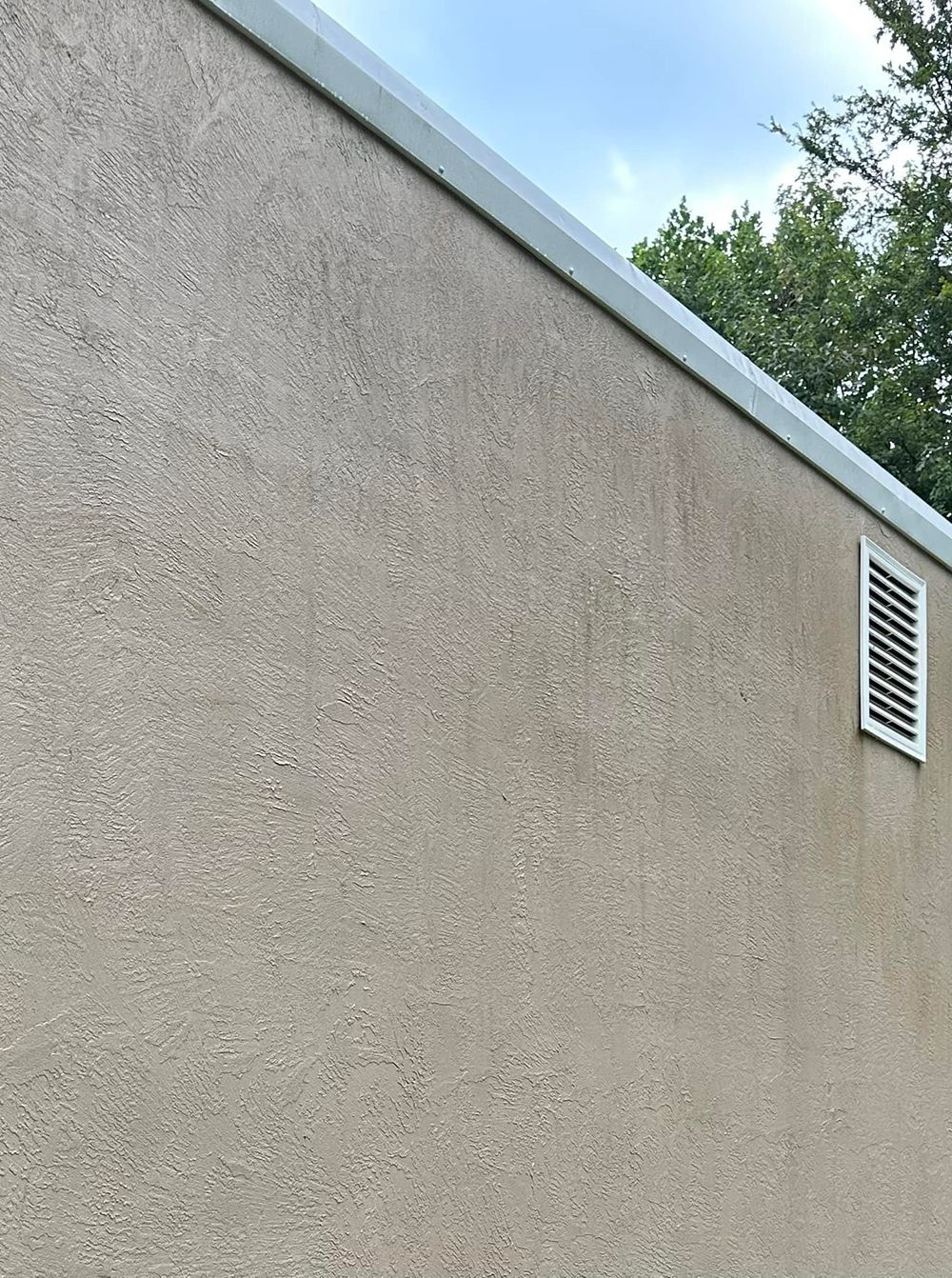 A close up of a wall with a vent on it