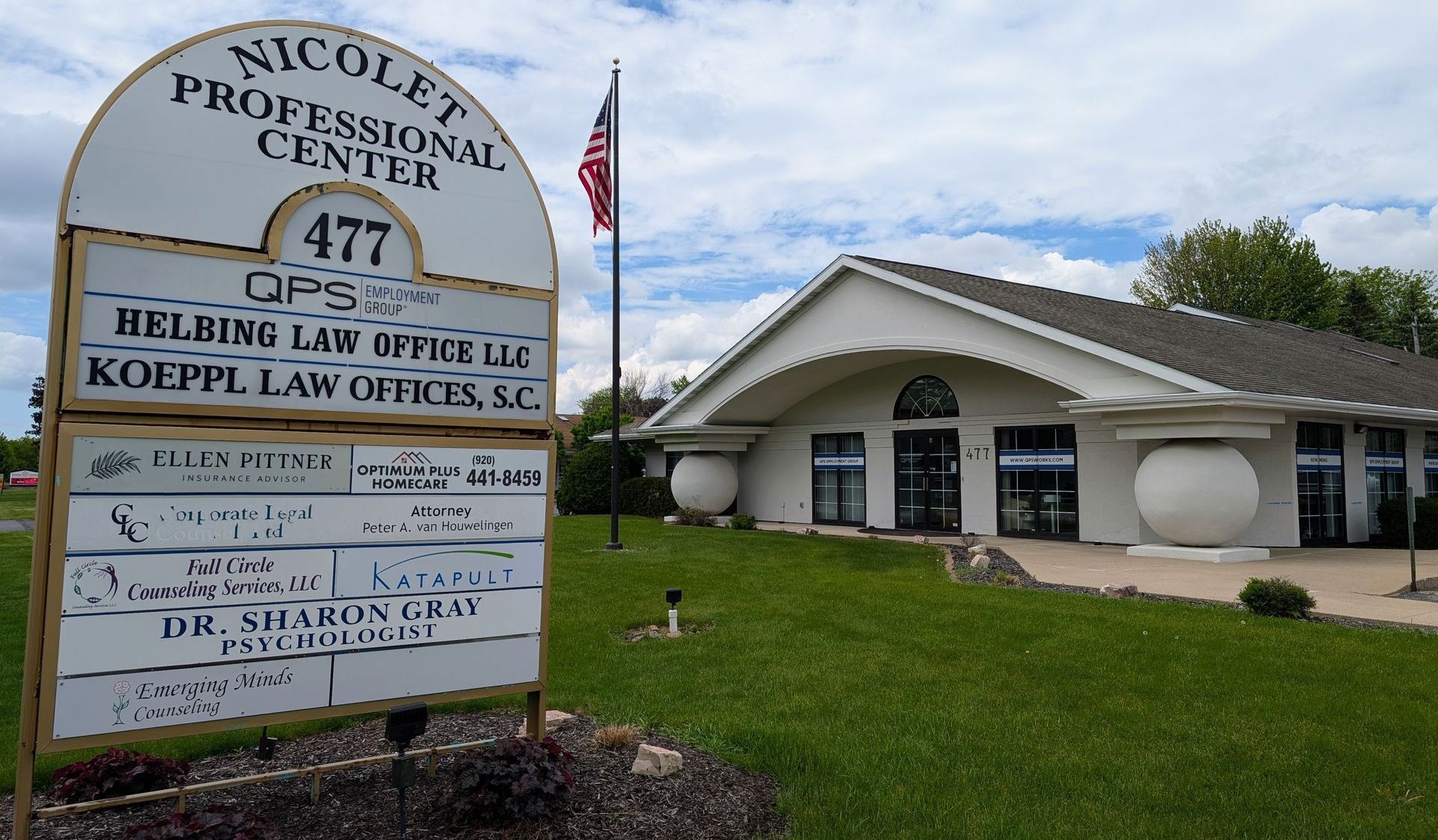A sign in front of a building that says nicole's professional center
