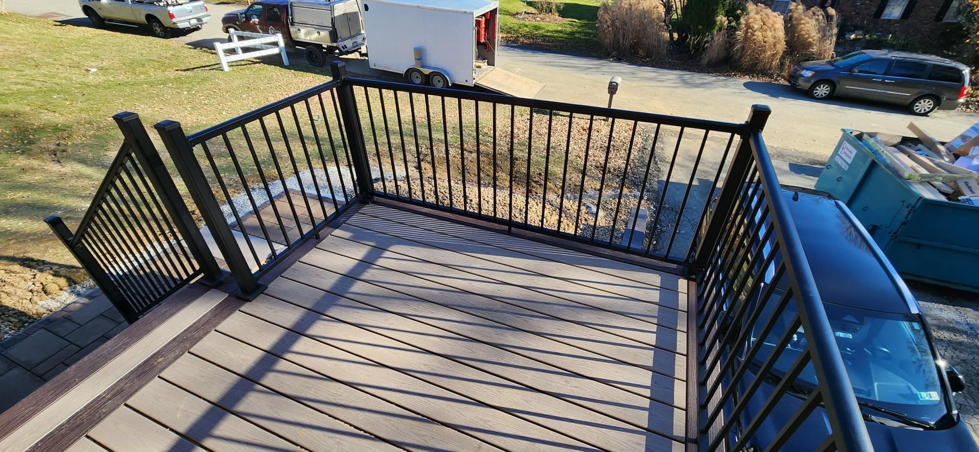 An aerial view of a deck with a metal railing and stairs leading up to it.