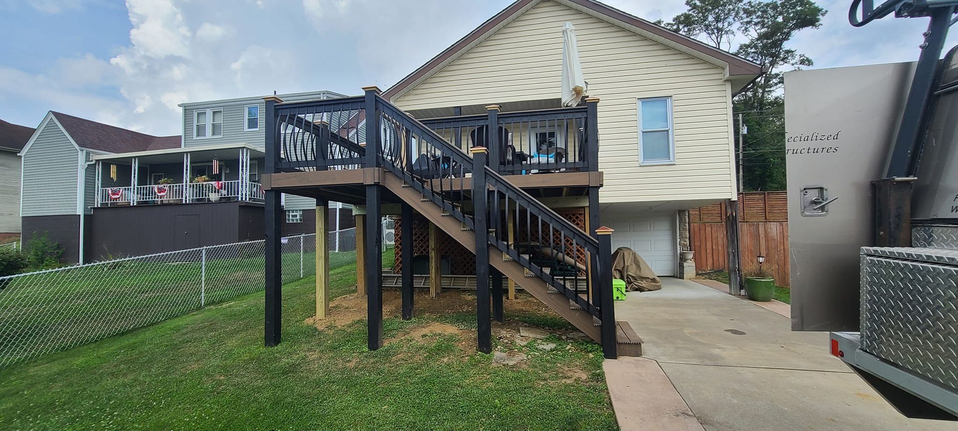 A house with a deck and stairs in front of it.