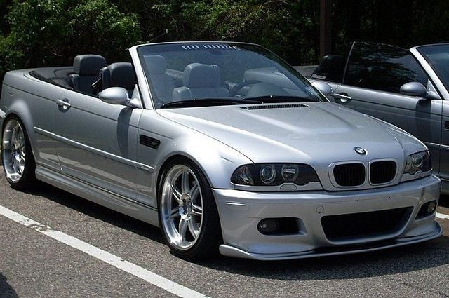 Silver BMW M3 convertible parked outdoors.